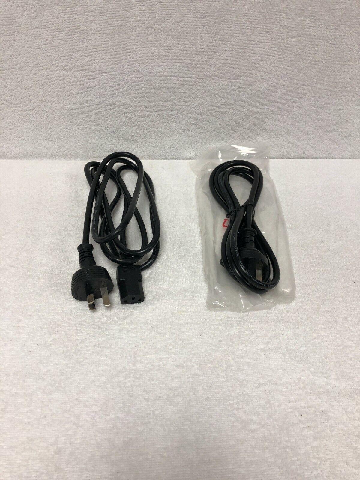 Pair of Australian power cords (one new, one used)